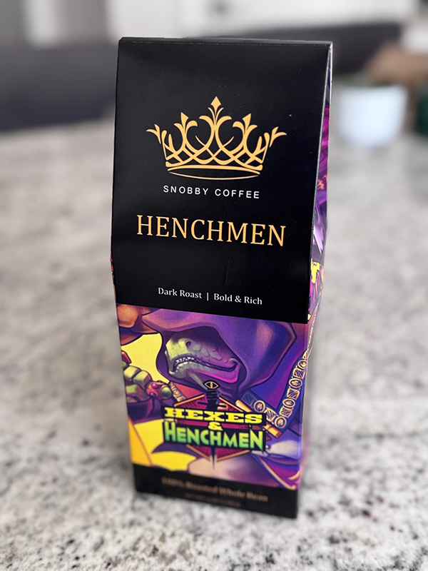 Coffee packaging with 'Henchmen' branding on a textured surface